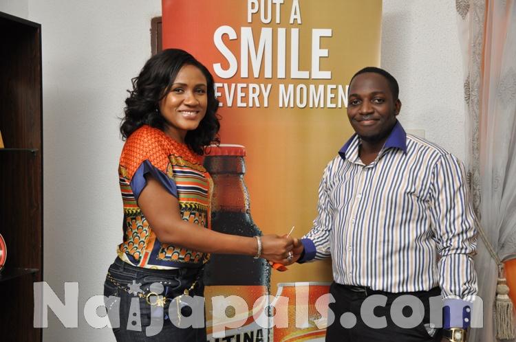 Ngozi Nkwoji, brand manager Maltina giving key to Maurice Eze