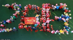 Pupils stand to form the shape of '2013' as they wait for the arrival of the new year at J