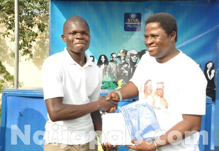 (R-L) Brand Manager Star, Omotunde Adenusi presenting iPad to one of the winners of Star League, Val