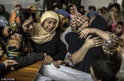 0003-2419D65F00000578-2875729-Grief_etched_across_their_faces_the_women_hug_one_another_in_vis-a-24_